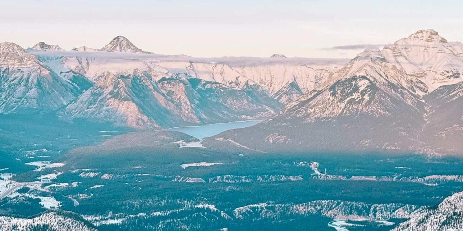 The mountains surrounding Banff, Canada from the top of a peak just outside of town.